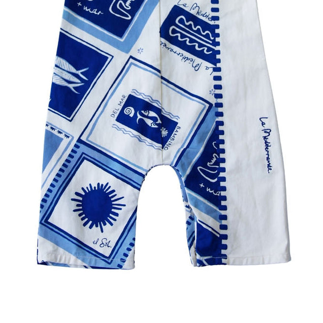 Baby romper with blue and white pattern on a white background